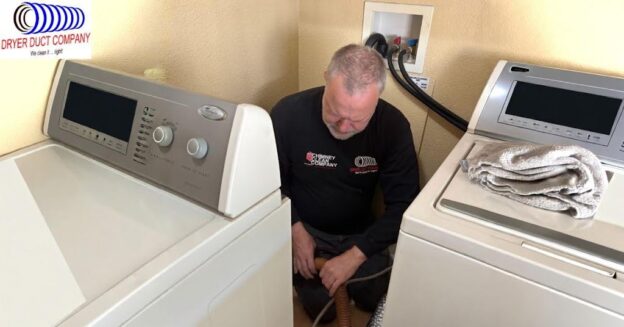 Technician performing dryer vent cleaning and removing lint buildup from a ceiling dryer duct for improved airflow and fire prevention